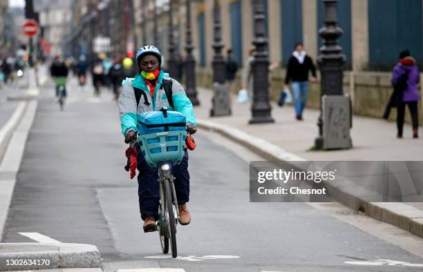 Food deliverer for Deliveroo rides his Velib bicycle during the coronavirus outbreak on February 17 in Paris, France. With the closure of...