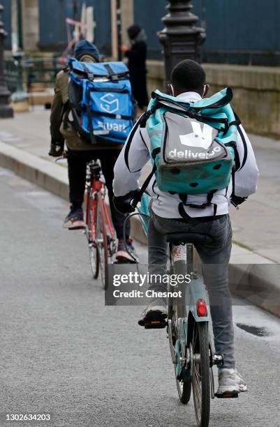 Food deliverers for Stuart and Deliveroo ride their bicycles during the coronavirus outbreak on February 17 in Paris, France. With the closure of...