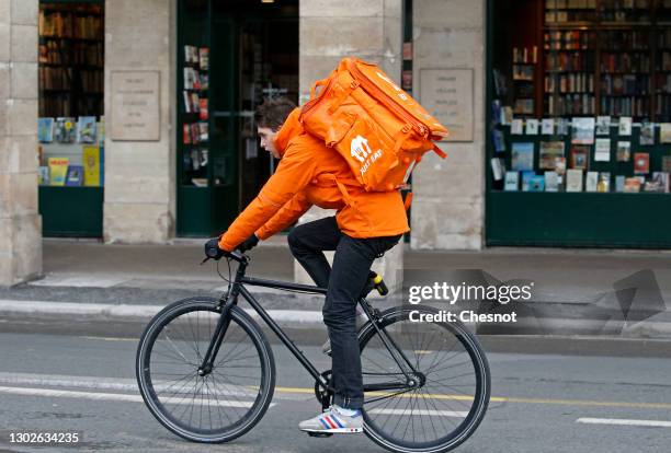 Food deliverer for Just Eat rides his bicycle during the coronavirus outbreak on February 17 in Paris, France. With the closure of restaurants, in...