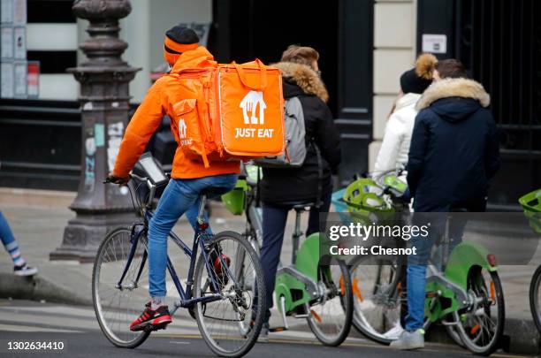 Food deliverer forJust Eat rides his bicycle during the coronavirus outbreak on February 17 in Paris, France. With the closure of restaurants, in...