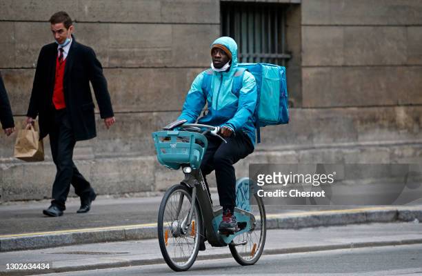 Food deliverer for Deliveroo rides his Velib bicycle during the coronavirus outbreak on February 17 in Paris, France. With the closure of...