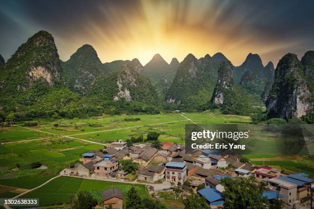 the village at karst terrain mountain area - national geographic society stock-fotos und bilder