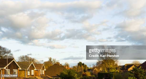 an elevated view of clouds at sunset in a suburban uk scene - stock photo - suburban background stock pictures, royalty-free photos & images