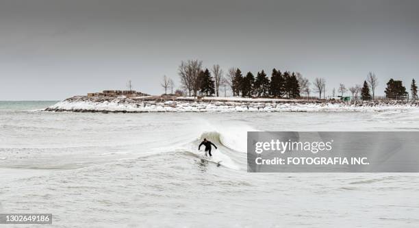 lake view with surfer on the waves - lake ontario stock pictures, royalty-free photos & images