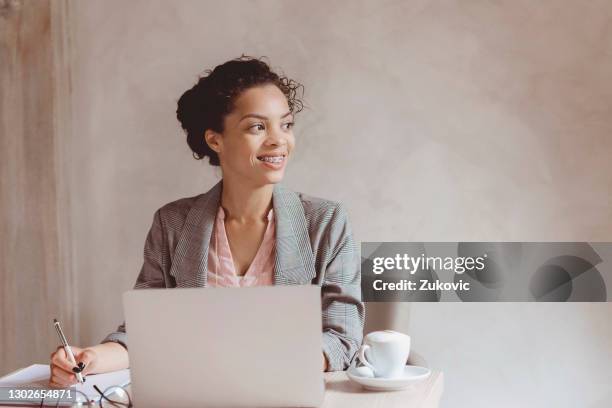 beautiful smiling young business woman using laptop - women pastel stock pictures, royalty-free photos & images