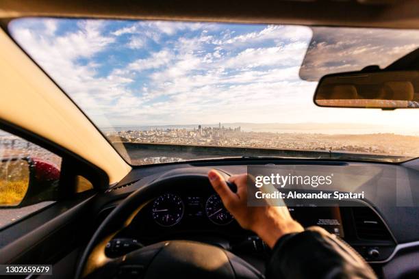 driving car in san francisco, personal perspective view, california, usa - car interior sunset stockfoto's en -beelden