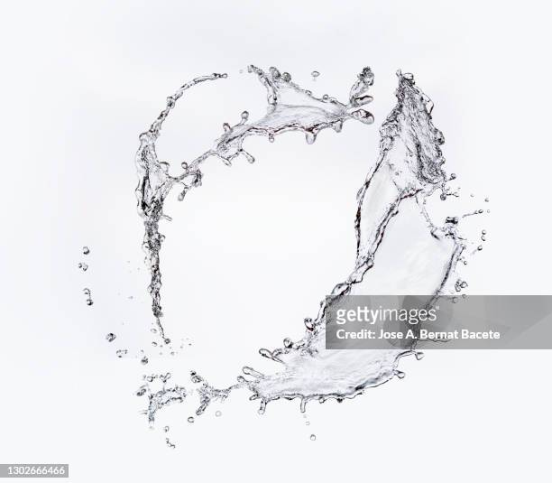 full frame of the textures formed  by the water jets to pressure with drops floating in the air on a white background - water photos et images de collection