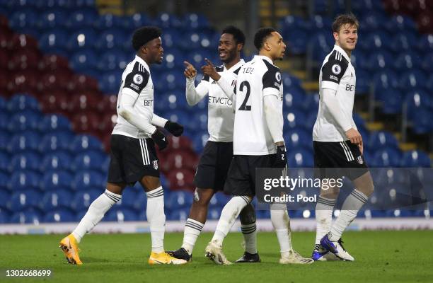 Ola Aina of Fulham celebrates with Josh Maja, Kenny Tete and Joachim Andersen after scoring his team's first goal during the Premier League match...