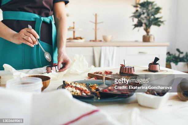 the chef prepares desserts made from chocolate and natural products to decorate the table. healthy sweets, gluten-free - woman cooking dessert bildbanksfoton och bilder