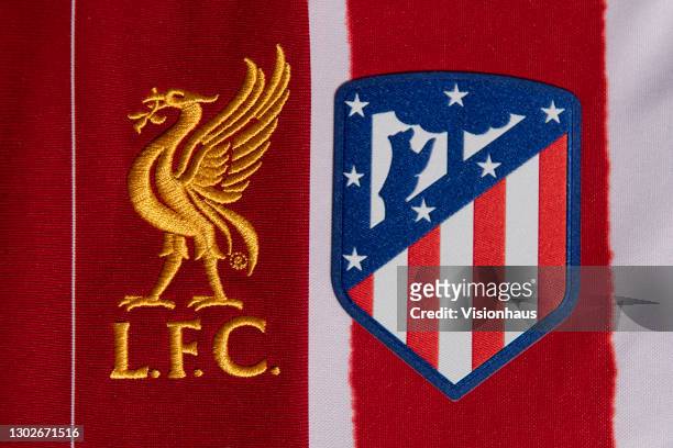 The Liverpool FC and Atletico Madrid club badges on their first team home shirts on February 11th, 2021 in Manchester, United Kingdom.