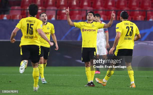 Mahmoud Dahoud of Borussia Dortmund celebrates with Raphael Guerreiro and Emre Can after scoring his team's first goal during the UEFA Champions...