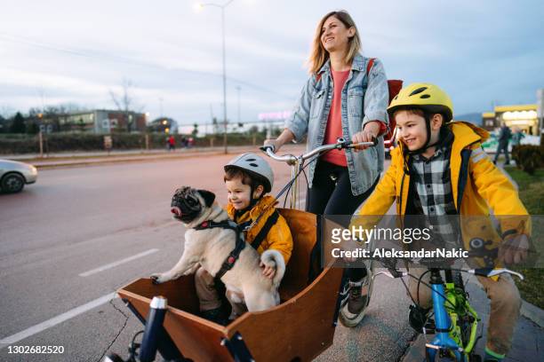 family biking in the city - city life stock pictures, royalty-free photos & images