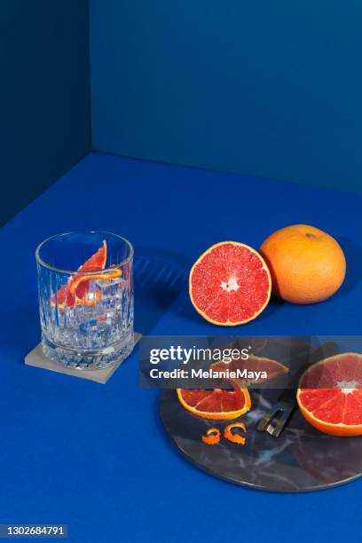 pop art style gin cocktail with grapefruit citrus fruit in blue background - gin tonic stock pictures, royalty-free photos & images