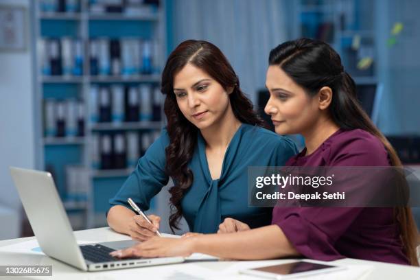 two business women working in office stock photo - india woman stock pictures, royalty-free photos & images