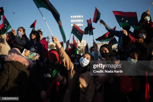 People wave flags and chant slogans during a gathering to commemorate the tenth anniversary of the Arab Spring in Martyrs Square on February 17, 2021...