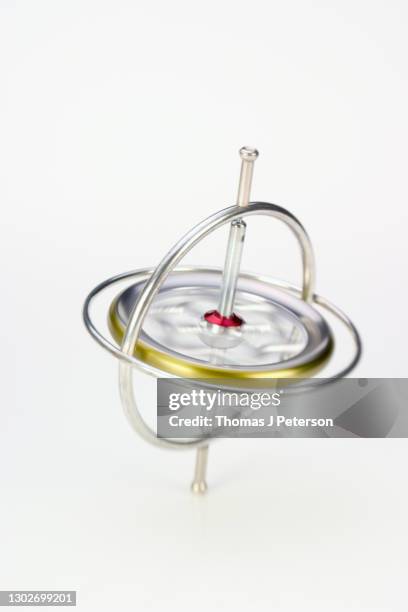 toy gyroscope spinning, close-up (blurred motion) - gyroscope stock pictures, royalty-free photos & images