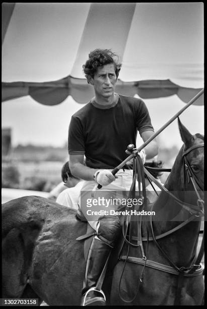 Prince Charles, Prince of Wales, sitting astride a polo pony with a polo mallet in his gloved right hand at the Palm Beach Polo and Country Club in...