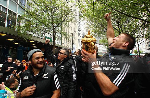 Brad Thorn of the All Blacks holds up the Webb Ellis Cup alongside Piri Weepu and Joe Locke during the New Zealand All Blacks 2011 IRB Rugby World...