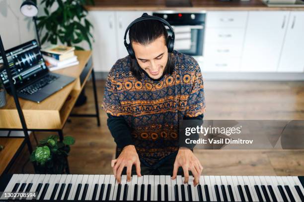 man playing the piano stock photo.  creating / recording music at home concept. - electric piano stock pictures, royalty-free photos & images