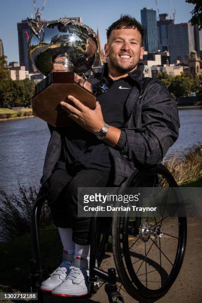 Dylan Alcott poses with the trophy after winning the 2021 Australian Open Quad Wheelchair Singles Title, at the Yarra River on February 18, 2021 in...