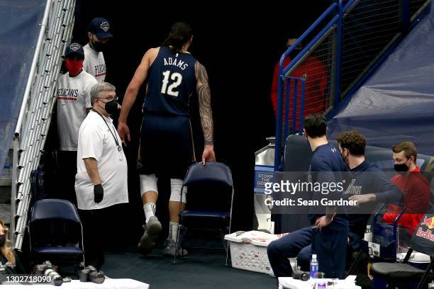 Steven Adams of the New Orleans Pelicans leaves the court after sustaining an injury during the first half of an NBA game against the Portland Trail...