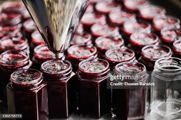 jars being filled with freshly made organic jam - jam jar stock pictures, royalty-free photos & images