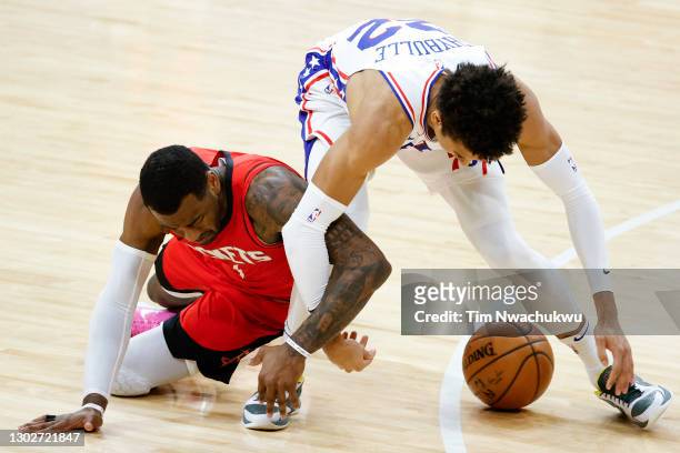 John Wall of the Houston Rockets and Matisse Thybulle of the Philadelphia 76ers reach for a loose ball during the fourth quarter at Wells Fargo...