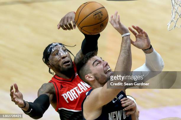 Robert Covington of the Portland Trail Blazers blocks the shot of Willy Hernangomez of the New Orleans Pelicans during the fourth quarter of an NBA...