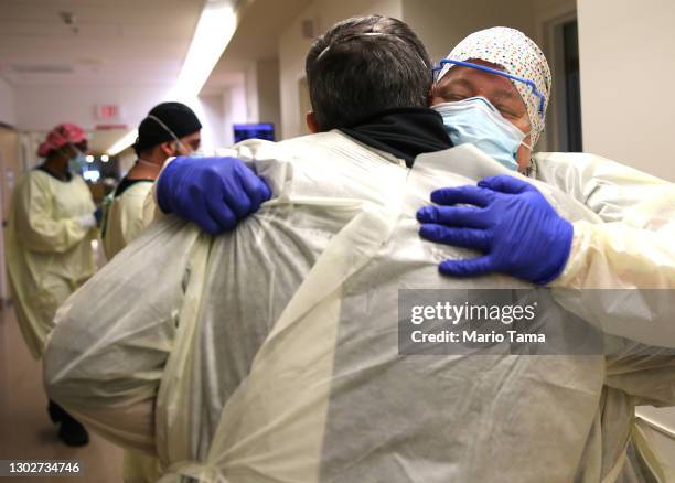 Chaplain Kevin Deegan hugs registered nurse Connie Carrillo at Providence Holy Cross Medical Center in the Mission Hills neighborhood on February 17,...