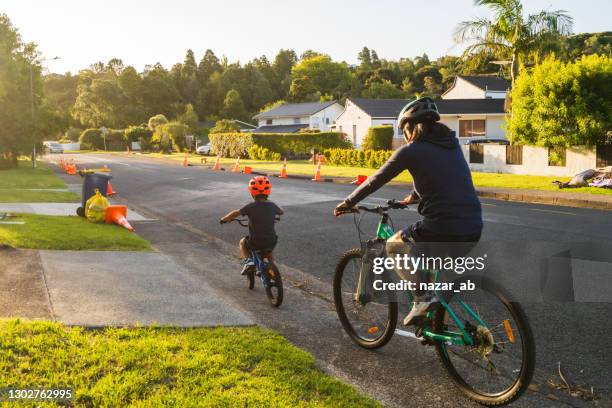 bike ride with kids in afternoon. - cycling streets stock pictures, royalty-free photos & images