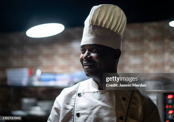 smiling chef in kitchen - catering black uniform stock pictures, royalty-free photos & images