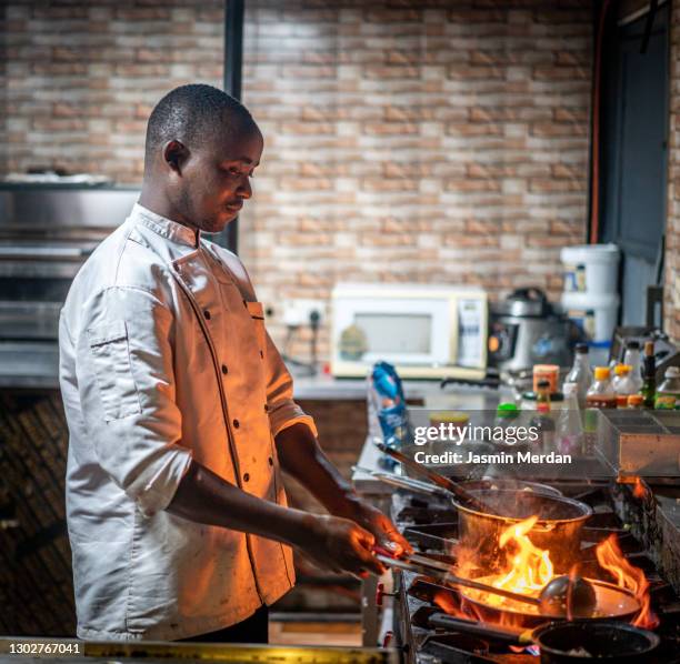 smiling chef in kitchen - black chef stock pictures, royalty-free photos & images