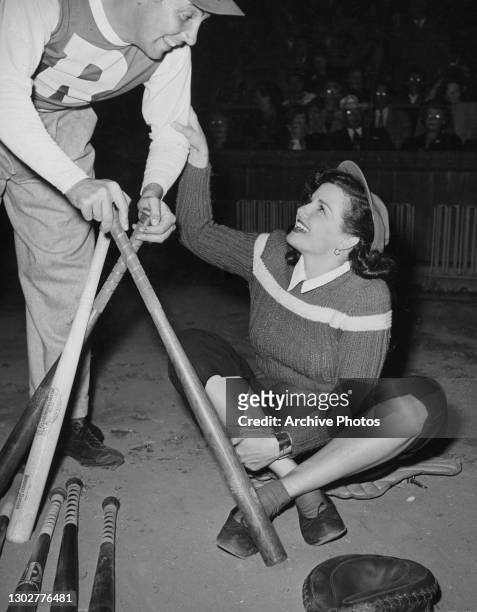American actress and singer Jane Russell takes part in the Runyon Cancer Fund baseball game at Gilmore Stadium, Los Angeles, US, 1947.