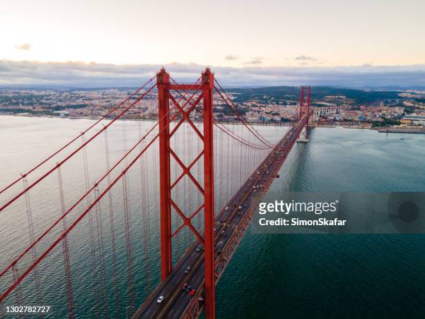 april 25th bridge at sunset, almada, lisboa region, portugal - lisbon stock pictures, royalty-free photos & images