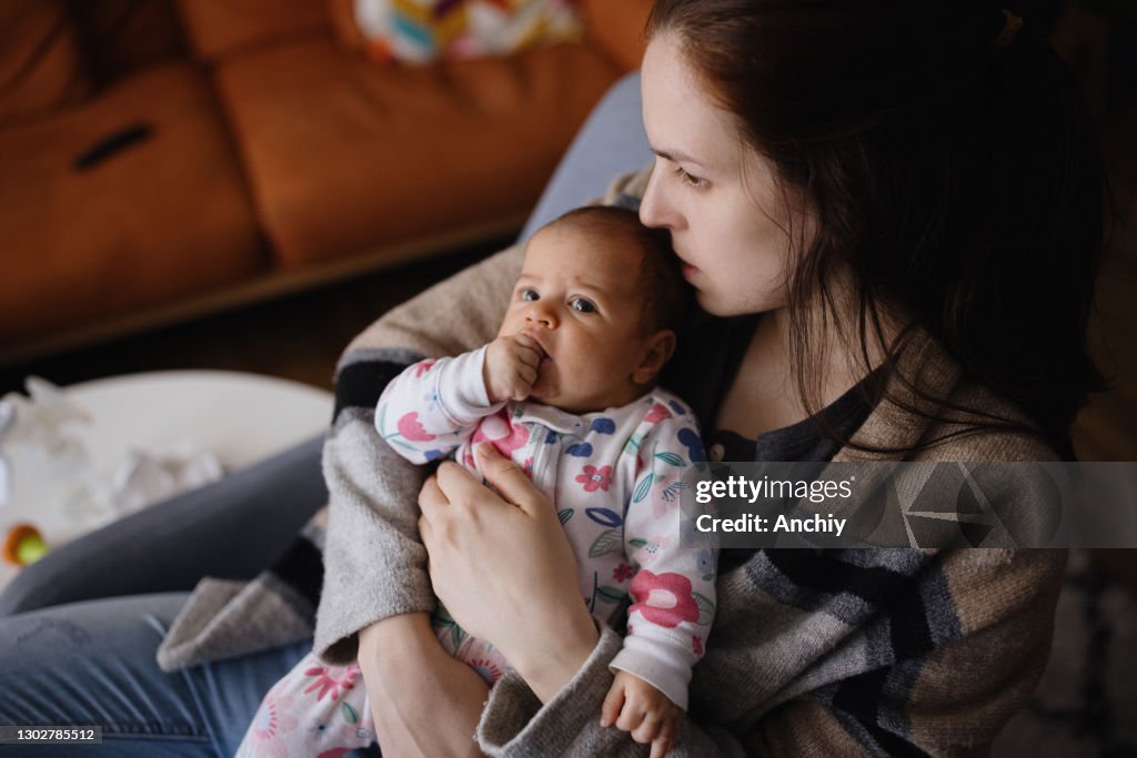 Single mom bonding with her newborn baby daughter