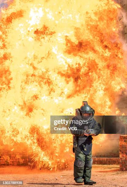 An explosive ordnance disposal member of Guangxi Armed Police Corps takes part in a drill on February 18, 2021 in Nanning, Guangxi Zhuang Autonomous...