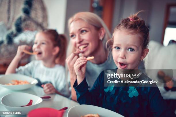 mother helping children develop healthy eating habits - family eating potato chips stock pictures, royalty-free photos & images