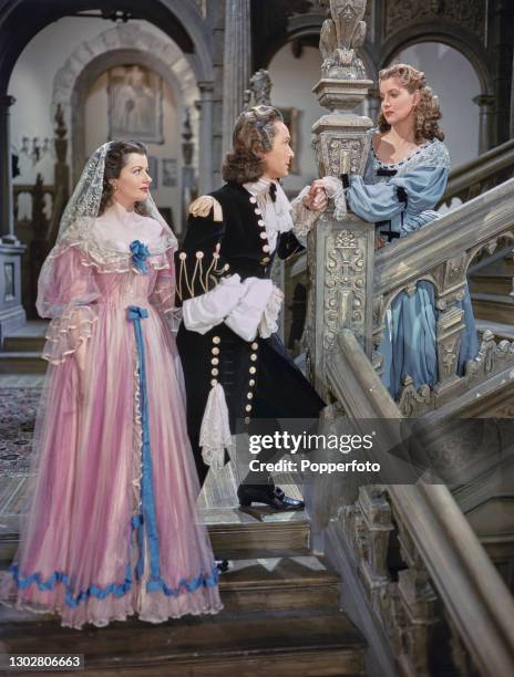 English actors, from left, Margaret Lockwood in character as Barbara Worth, Griffith Jones as Sir Ralph Skelton and Patricia Roc as Caroline in a...
