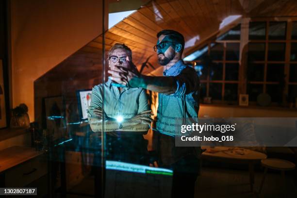 working in the office late at night - film projector screen stock pictures, royalty-free photos & images