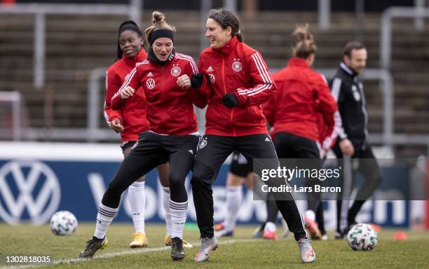 Alexandra Popp warms up with former national player and team mental coach Birgit Prinz during a training session at Suedstadion on February 18, 2021...