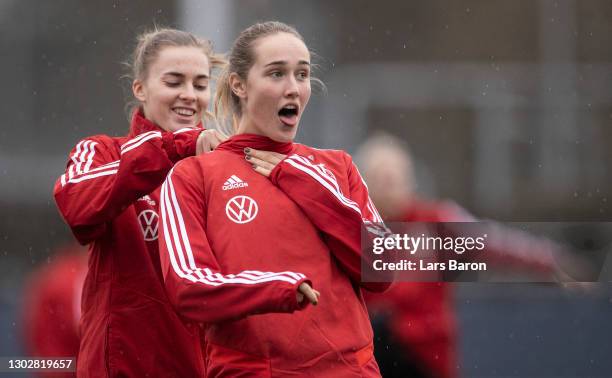 Laura Freigang jokes with team mate Sydney Lohmann during a training session at Suedstadion on February 18, 2021 in Cologne, Germany.Germany plays...