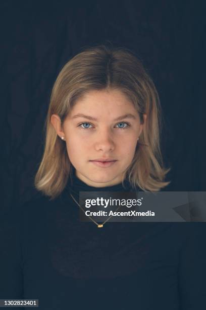 portrait of young woman modelling jewelry in studio - mid length hair stock pictures, royalty-free photos & images