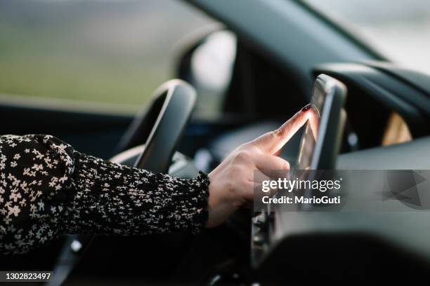 woman touching the touch screen of a car - sirius stock pictures, royalty-free photos & images