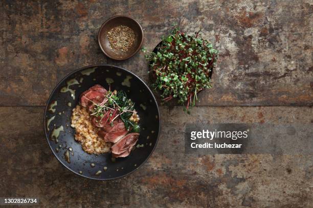 grilled venison steak with spelt grain - deer stock pictures, royalty-free photos & images