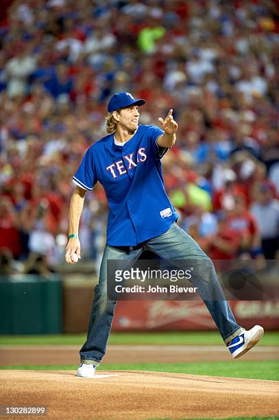 World Series: Dallas Mavericks player Dirk Nowitzki throwing out ceremonial first pitch before Texas Rangers vs St. Louis Cardinals Yadier Molina in...
