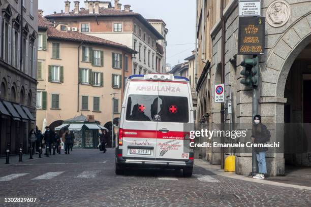 An ambulance of the Italian Red Cross is pictured driving in the streets on February 18, 2021 in Bergamo, Italy. The northern Italian province of...