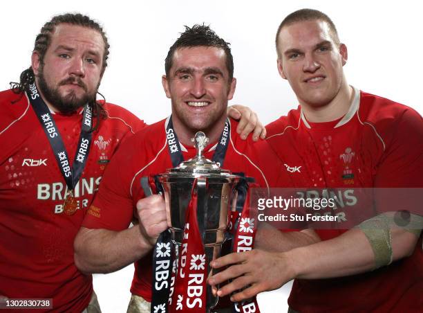 Wales Front Row players left to right, Adam Jones, Huw Bennett and Gethin Jenkins celebrate with the 6 Nations Trophy after the RBS Six Nations...