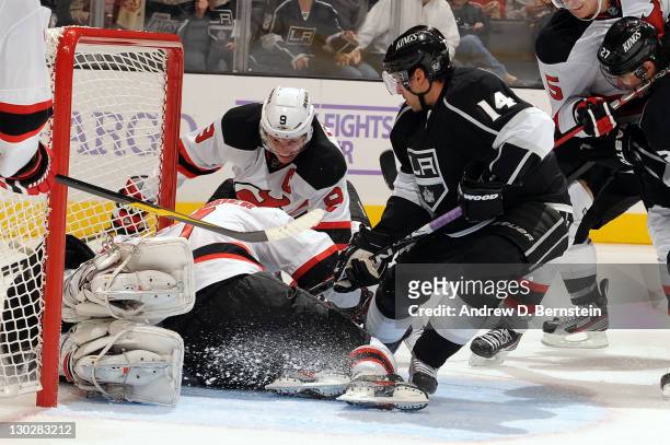 Justin Williams of the Los Angeles Kings tries to score against Johan Hedberg and Zach Parise of the New Jersey Devils at Staples Center on October...