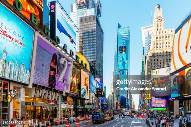 crowded times square on a sunny morning, new york city, usa - fifth avenue stock pictures, royalty-free photos & images