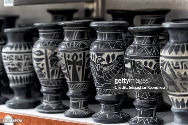a row of carved alabaster vase available as souvenirs in luxor, egypt. - ancient vase stock pictures, royalty-free photos & images